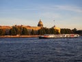 Saint-Petersburg, Russia. 08.31.2019. View of St. Isaacs Cathedral and the Neva River with a tourist boat at sunset Royalty Free Stock Photo